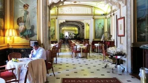 a man sitting at a table in a restaurant at Latt e Liett in Naples