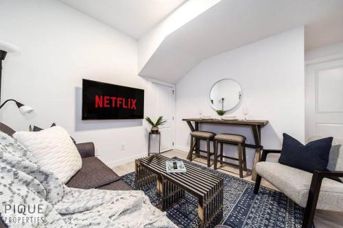 a living room with a couch and a table at *NEW* Modern Suite King Bed! Netflix! Sleeps 4! in Edmonton