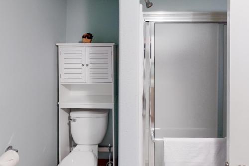 a white bathroom with a toilet and a shower at Jefferson Joy in Eugene