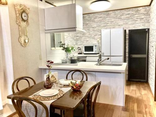 a kitchen with a wooden table and chairs in a kitchen at Ikebukuro Sta 8 mins Good Access Modern House TS0318 in Tokyo