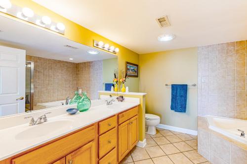 a bathroom with two sinks and a tub and a toilet at Bahia Vista I 204 in Ocean City