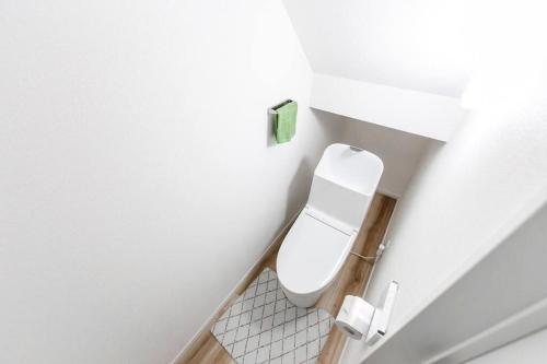 W tym białym pokoju znajduje się łazienka z toaletą. w obiekcie THE SUN w mieście Sapporo