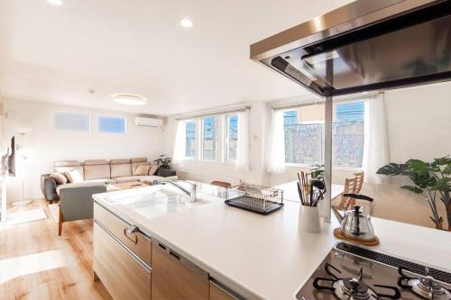 a kitchen and living room with a stove top oven at THE SUN in Sapporo