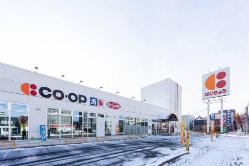 a coop store on a snow covered street at THE SUN in Sapporo
