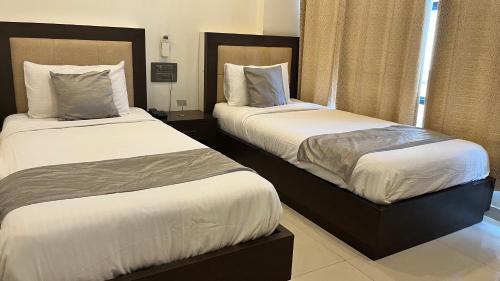 Ein Bett oder Betten in einem Zimmer der Unterkunft K Plus Comforts