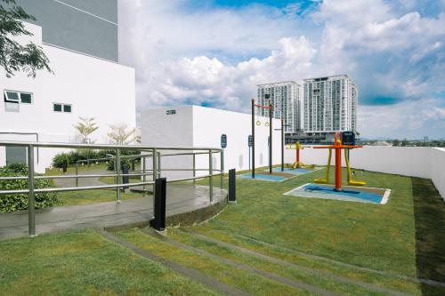a playground in front of a building with a tall building at METROPOL SERVICED APARTMENT at Bukit Mertajam, Pulau Pinang in Bukit Mertajam