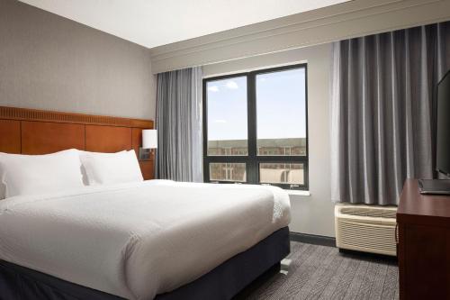 a hotel room with a bed and a large window at Courtyard by Marriott Washington Capitol Hill/Navy Yard in Washington