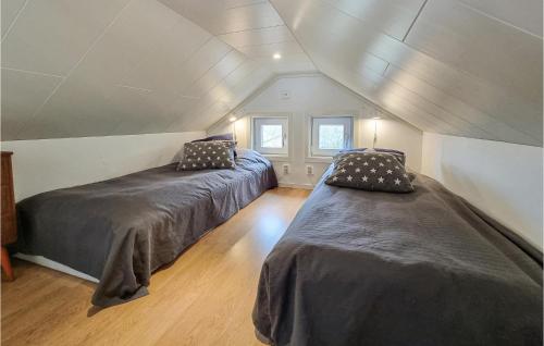 a attic bedroom with two beds in a room at 2 Bedroom Lovely Apartment In Lysekil in Lysekil