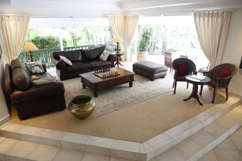 a living room with a couch and a table at Cinnamon Boutique Guest House in Wilderness