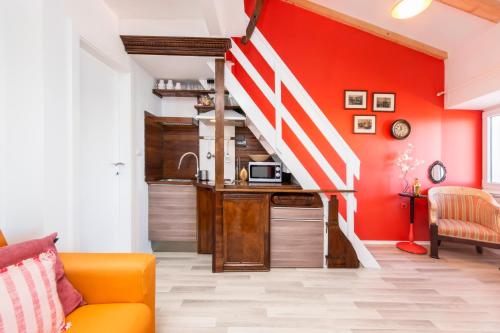 a living room with an orange couch and a staircase at Loreto LYA SEA VIEW APARTMENTS in Rovinj