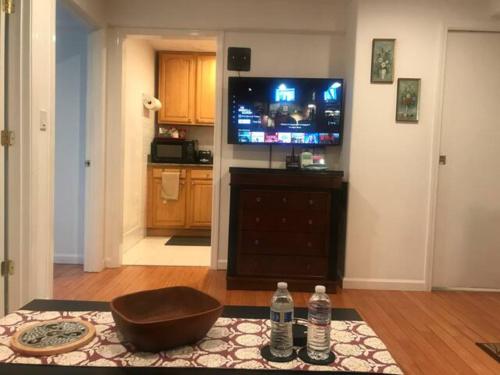a living room with a television and two water bottles at 2 Bedroom Apartment with Parking near City College of SF in San Francisco
