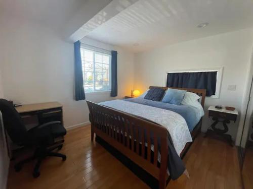 a bedroom with a bed and a desk and a chair at 2 Bedroom Apartment with Parking near City College of SF in San Francisco
