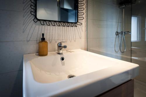 a bathroom with a white sink and a mirror at Loreto LYA SEA VIEW APARTMENTS in Rovinj