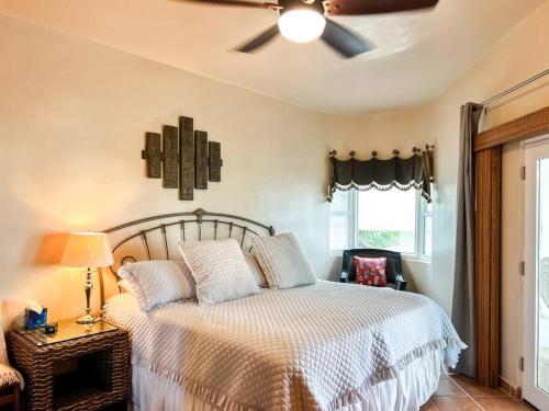 a bedroom with a bed with a ceiling fan at Sandy Beach Costa Diamante House E10 Dog Friendly in Puerto Peñasco