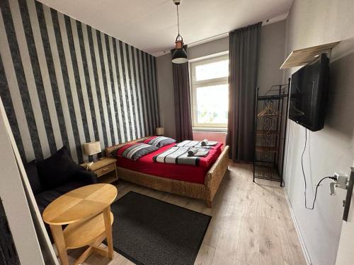 ein kleines Zimmer mit einem Bett und einem Sofa in der Unterkunft Adam's Hostel - Self Check-In & Room Just For You Alone in Düsseldorf