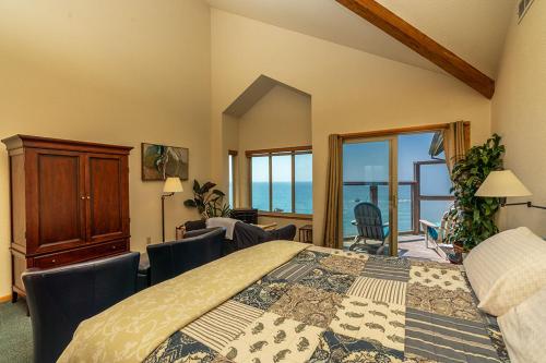 a bedroom with a bed with a view of the ocean at Turtle Rocks Oceanfront Inn in Trinidad