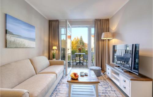 a living room with a couch and a tv at Baltischer Hof Apartment 36 in Boltenhagen