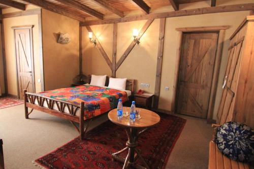 a bedroom with a bed and a table in it at Khan Lankaran Hotel in Lankaran