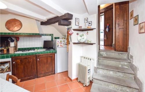 a kitchen with a staircase and a refrigerator at 3 Bedroom Lovely Apartment In Nespolo in Nespolo