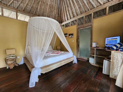 Ένα ή περισσότερα κρεβάτια σε δωμάτιο στο Bamboo Lodge 2