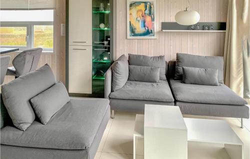 a living room with a couch and a table at Friedrichskoog-Strandpark 15 in Friedrichskoog