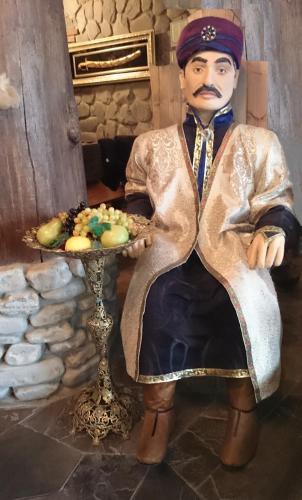 a statue of a man holding a plate of fruit at Khan Lankaran Hotel in Lankaran