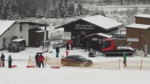 a group of people in the snow in front of a building at Gasthof zum Österntor in Medebach