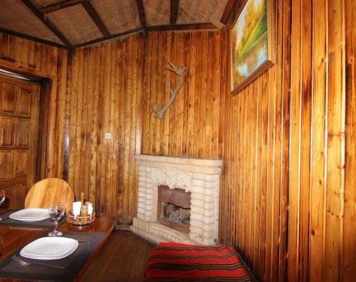 a bathroom with a fireplace in a wooden wall at Khan Lankaran Hotel in Lankaran