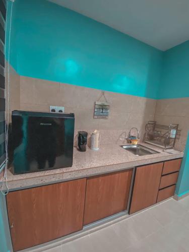 a kitchen with a sink and a counter top at Al-Mughni Homestay in Pasir Gudang