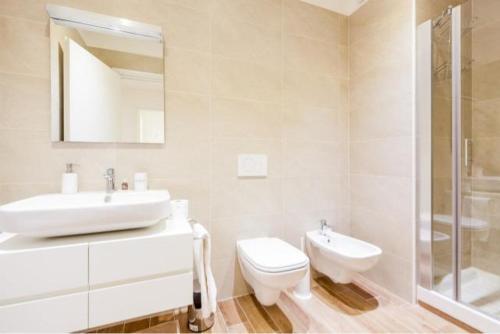 a bathroom with a sink and a toilet and a shower at Corte Spagnola in Verona