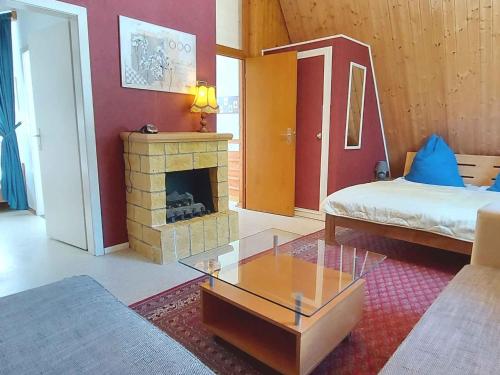 a living room with a bed and a fireplace at Holiday home in Bad Mitterndorf - Steiermark 41125 in Bad Mitterndorf