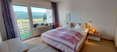 a bedroom with a bed and a large window at Apartment in Bad Mitterndorf - Steiermark 36988 in Bad Mitterndorf