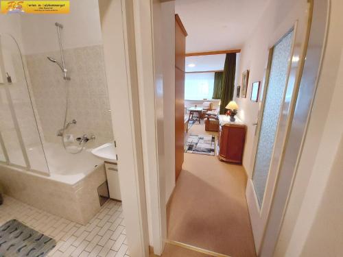a bathroom with a tub and a shower and a sink at Studio in Bad Mitterndorf - Steiermark 41118 in Bad Mitterndorf
