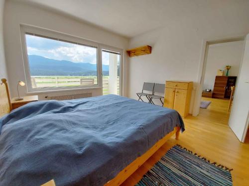 a bedroom with a bed and a large window at Apartment in Sonnenalm - Salzkammergut 37018 in Reith
