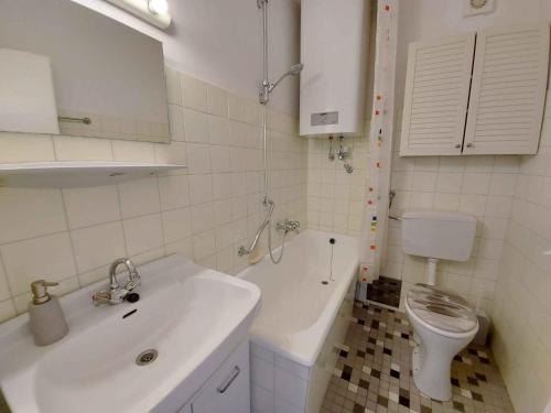 a white bathroom with a sink and a toilet at Apartment in Sonnenalm - Salzkammergut 37018 in Reith