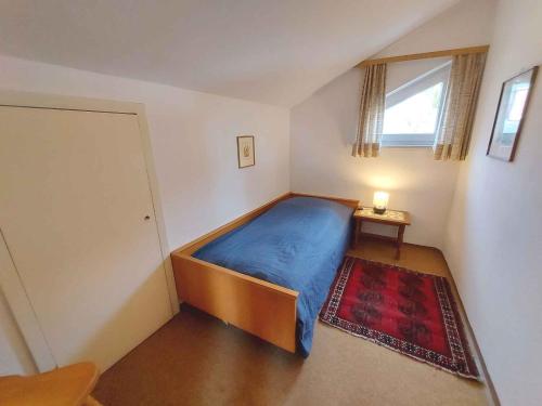 um quarto com uma cama azul e uma janela em Holiday home in Bad Mitterndorf - Steiermark 41120 em Bad Mitterndorf