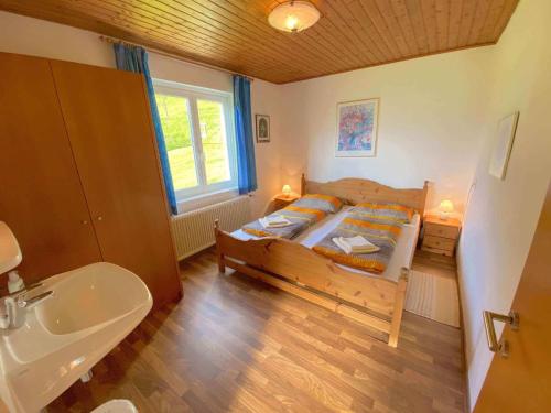 a bedroom with a bed and a sink and a tub at Holiday home in Radstadt - Salzburger Land 352 in Radstadt