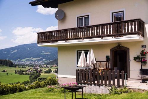 a house with a balcony and a table with umbrellas at Holiday home in Radstadt - Salzburger Land 352 in Radstadt