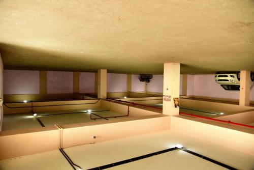 a room with three beds with a car on the wall at Hotel Chembiyan in Pudukkottai