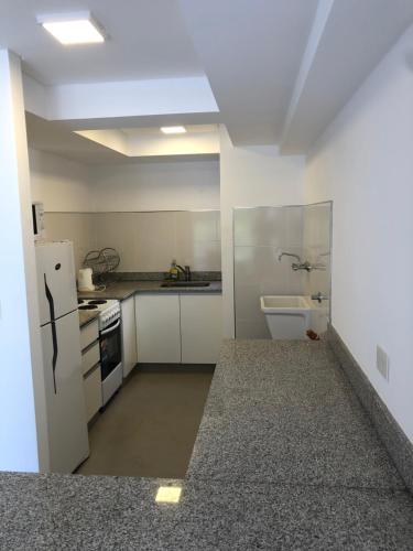 a small kitchen with a refrigerator and a sink at Departamento equipado en mejor zona del centro de Salta in Salta