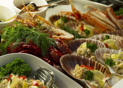 a table full of different types of seafood and vegetables at Fleischer's Hotel in Vossevangen