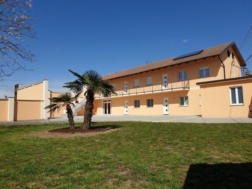 a building with a palm tree in front of it at Via Casne 2 Volpiano (TO) in Volpiano
