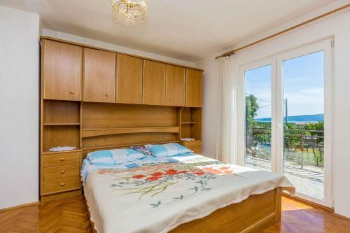 a bedroom with a large bed and a large window at Apartment in Skrpcici - Insel Krk 41816 in Skrbčići