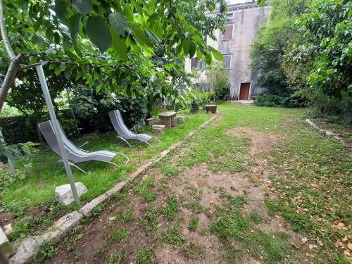 a garden with two benches in the grass at Holiday home in Krnica - Istrien 42505 in Krnica