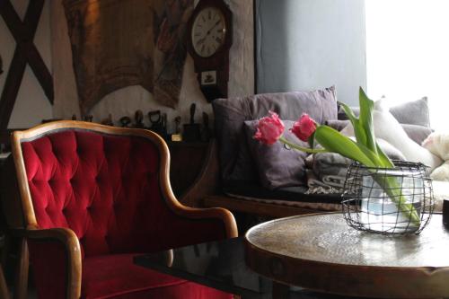 a living room with a red couch and a table at Alp Art Hotel Götzens in Innsbruck
