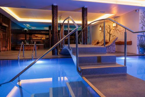 a swimming pool with stairs in a hotel at Lavendel Spa Hotel in Tallinn
