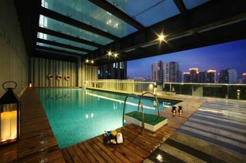 einem Pool auf einem Gebäude mit Skyline der Stadt in der Unterkunft Rhombus Park Aura Chengdu Hotel in Chengdu