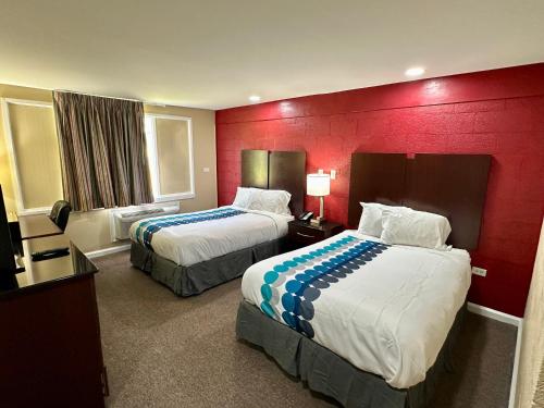 Beech Island的住宿－Royal Inn - North Augusta - Home Of The Masters - Augusta Downtown，酒店客房设有两张床和红色的墙壁。