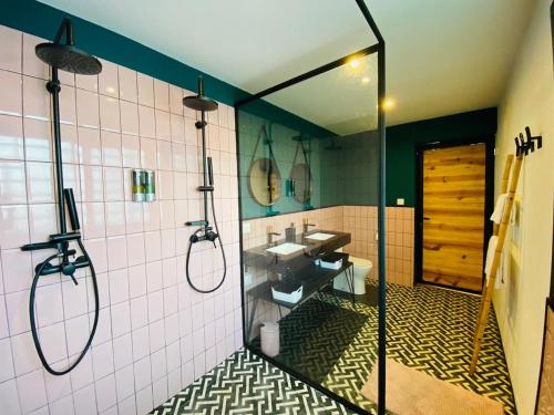 a bathroom with a shower and a sink and a mirror at Joyau secret # Jardin # Piscine # Bien-être # prox centre ville in Antananarivo