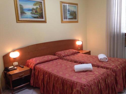 Posteľ alebo postele v izbe v ubytovaní Hotel La Caravella